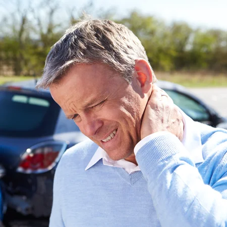 A man holding his neck in pain after an auto accident
